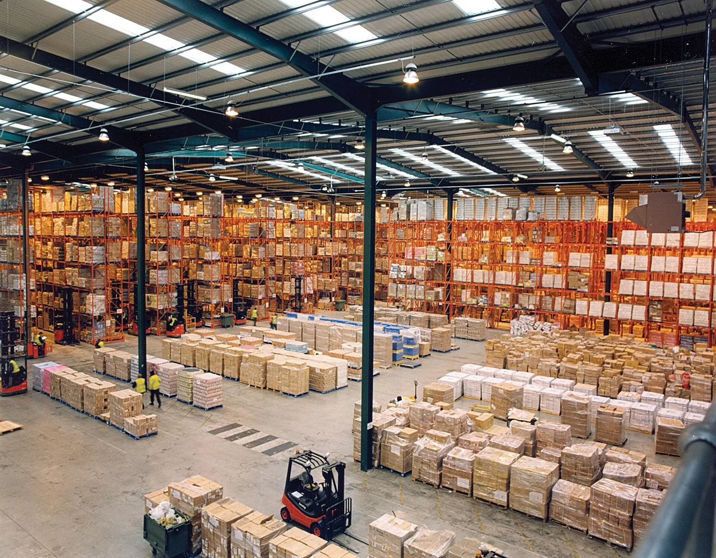 Pallet racks and boxed goods inside an operating warehouse